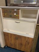 A mid-century kitchen cabinet with drop-down front