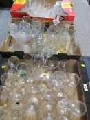 Three trays of assorted glassware to include decanters and a selection of cut glass drinking glasses