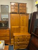 A modern honey pine double wardrobe with a pair of bedside chests and chest of drawers