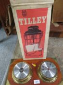 A vintage boxed tilly lamp together with a wall mounted clock barometer