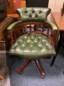 A green leather swivel office tub chair