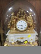 A gilt figural and marble French drum head mantle clock under glass dome