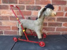 A Merrythought push a long toy donkey