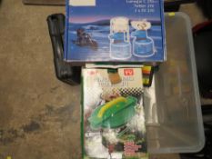 A boxed compact garden hose reel and spray head, boxed portable gas stove, boxed camping gas