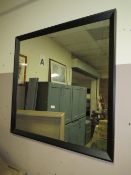 A large modern black framed wall mirror 100 x 100 cm