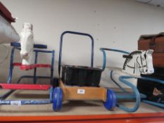 Two vintage child's rockers together with a push along building blocks trolley