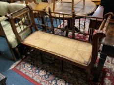 An antique oak spindle back wicker seated bench seat W 133 cm
