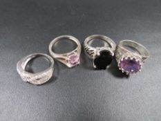 A selection of four silver and other dress rings