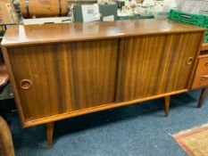 A mid-century teak sliding door sideboard