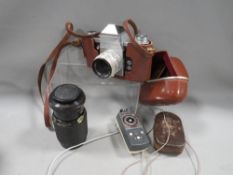 A cased Practika camera and accessories to include a zoom lens