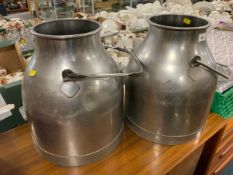 A pair of stainless steel milk buckets