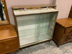 A mid-century glass floral display cabinet