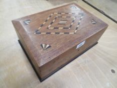 A vintage inlaid mahogany box with drawers