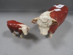 A Beswick Hereford Bull with a Beswick Hereford calf (2)