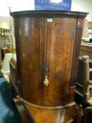 An antique oak and mahogany inlaid hanging corner cupboard