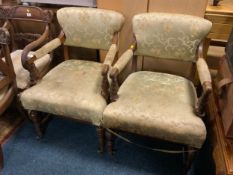 A pair of Edwardian oak upholstered armchairs