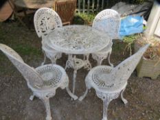 A cast aluminium garden patio table set with four chairs