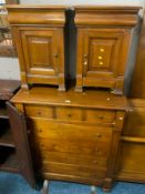 A modern cherrywood seven drawer chest together with a pair of modern cherrywood bedside chests