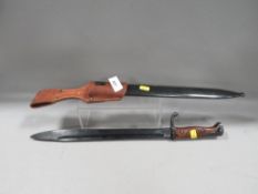 A bayonet in steel scabbard, with leather frog