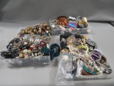 Three small trays of mixed costume jewellery