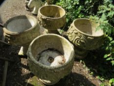Four concrete planter urns with pedestals