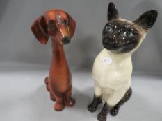 A Beswick fireside Seal Point cat together with a figure of a Dachshund (2)