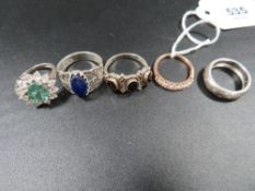 A selection of five silver and other dress rings