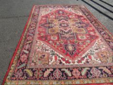 A large 20th century woollen rug 306×208 cm