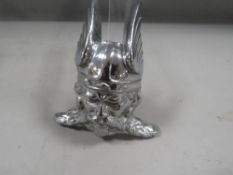 A vintage chrome effect car badge from a rover