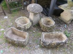 Four concrete garden planters together with a staddle stone