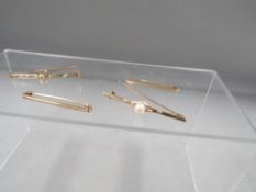 Three 9ct bar brooches together with an unmarked example approx. combined weight 8.2g