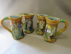 Four reproduction majolica style tankards