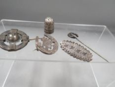 Antique silver and white metal jewellery, consisting of 3 brooches, a stick pin, together with a