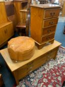 A light oak four drawer media cabinet together with a four drawer chest and an eastern pouffe
