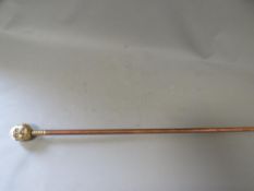 A brass topped copper walking stick