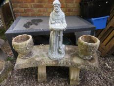 A concrete garden bench with two concrete garden urn planters and a plastic statue