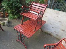 A cast iron bench and chair