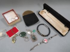 A selection of costume jewellery, powder compact etc.
