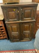 An antique oak four door cabinet A/F