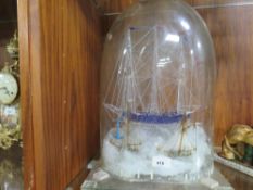 An unusual glass model of a tall ship under a glass dome