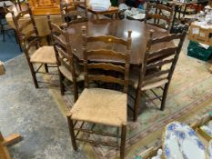 A carved Edwardian oak octagonal table together with six later ladderback wicker seat chairs Table