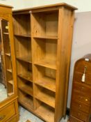 A modern honey pine open double bookcase