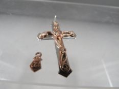 A hallmarked silver cross mounted with Clogau gold decoration together with Tag