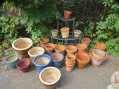 A selection of ceramic and terracotta planters together with a metal 3 tier plant stand