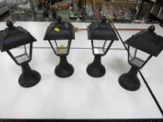 A box of four garden lamps