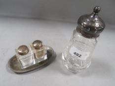 A hallmarked silver topped sugar caster together with white metal two bottle cruet on fitted tray