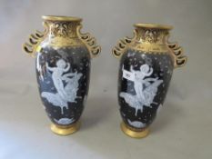 A pair of reproduction gilded black pate sur pate vases