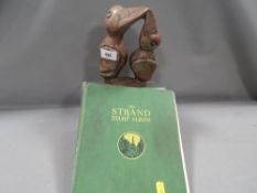 An African soap style carving of two birds together with a strand stamp album and contents