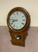 An antique mahogany case wall clock