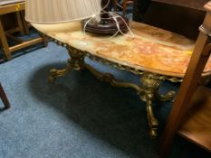 An oval onyx coffee table together with a mahogany standard lamp and shade